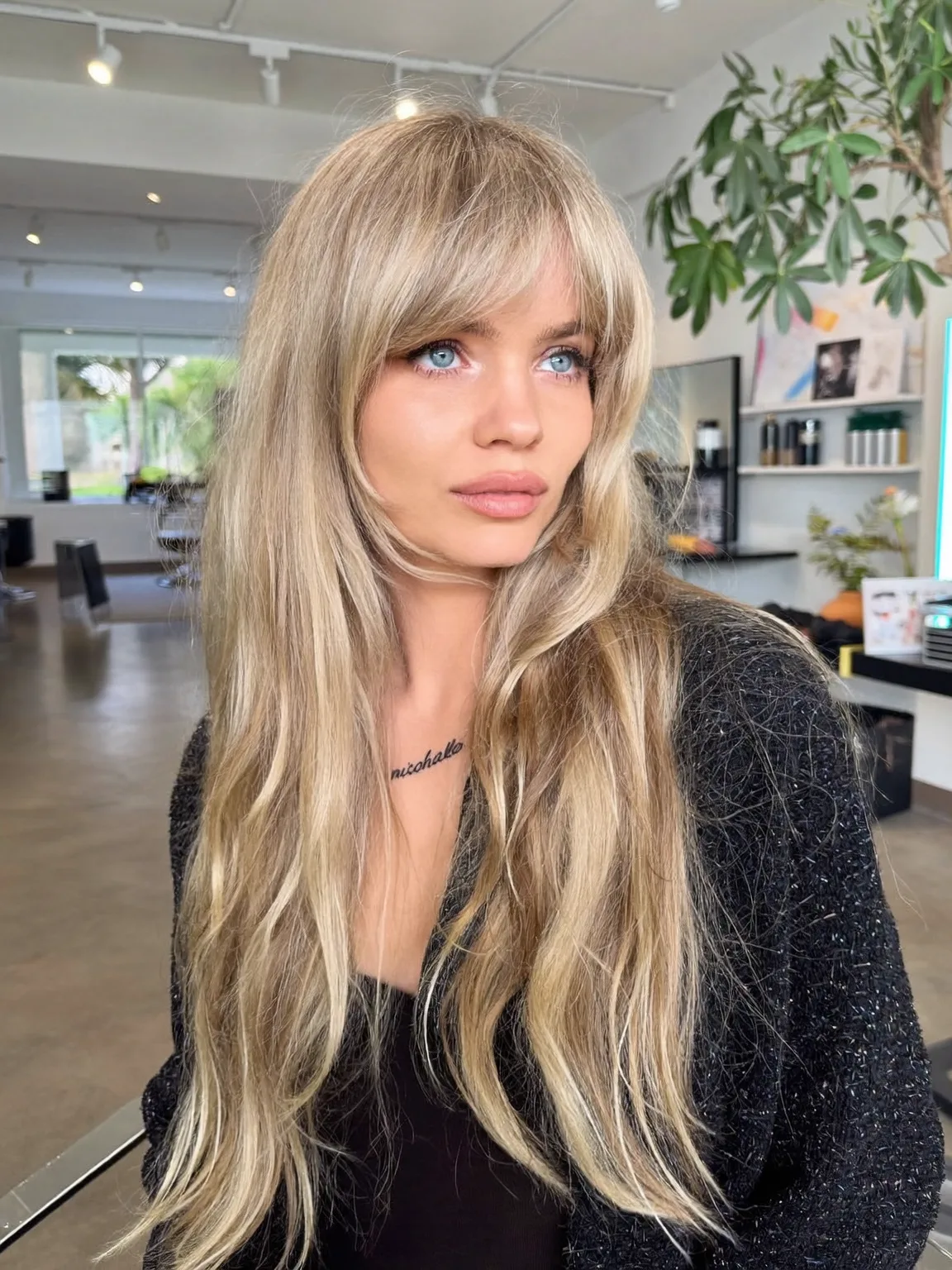 Long Wavy Sandy Blonde Layers with Curtain Bangs